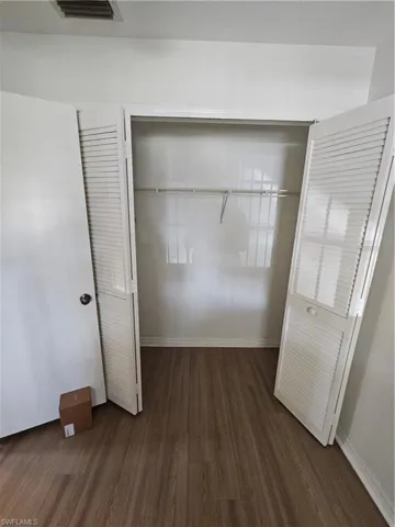 Louvered bi-fold doors open to a closet space featuring a wire shelving system