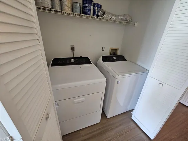 Dedicated laundry area with durable wood-finish flooring