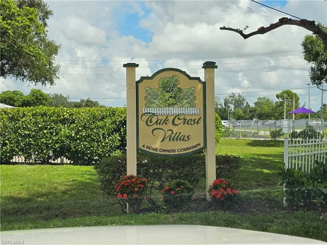 "Oak Crest Villas" community entrance sign featuring decorative landscaping