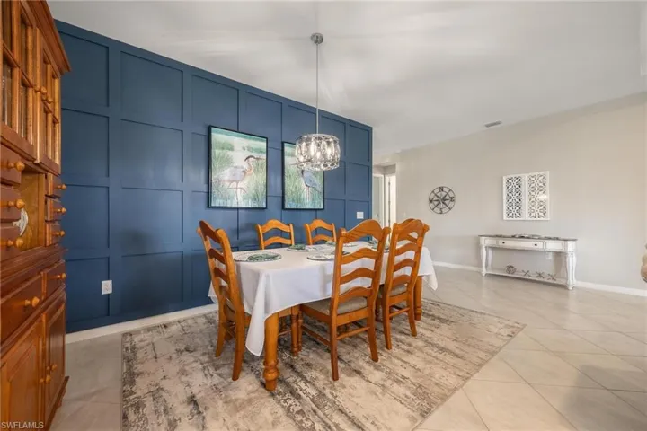 Tiled dining area with a chandelier