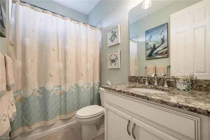 Full bathroom featuring tile patterned flooring, vanity, shower / tub combo, and toilet