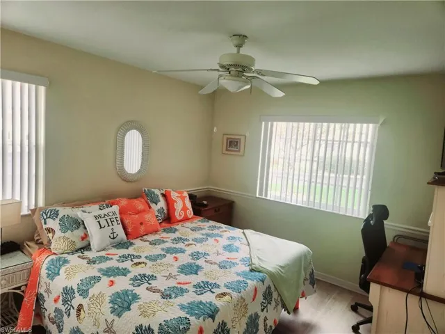 Bedroom with light hardwood / wood-style floors and ceiling fan