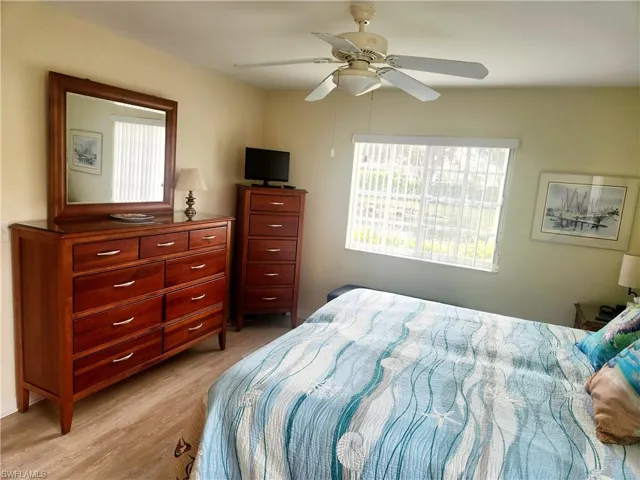 Bedroom with light hardwood / wood-style flooring and ceiling fan