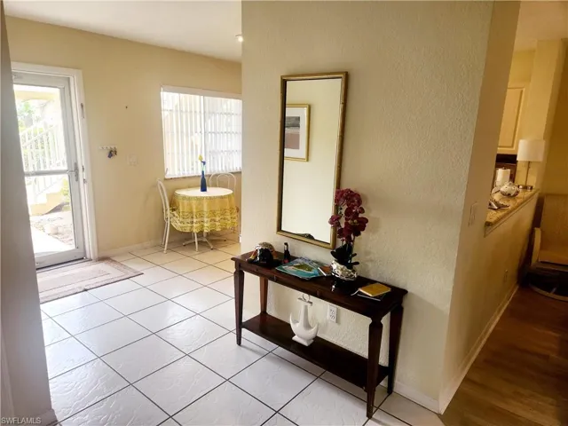 Doorway to outside featuring light tile patterned floors