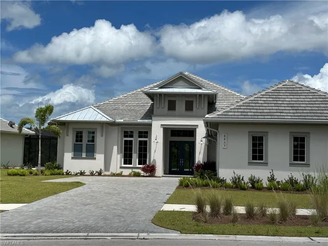 View of front of home with french doors and a front lawn