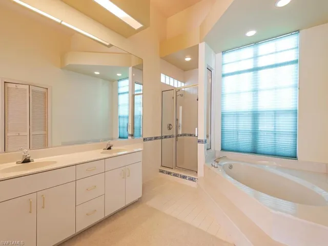 Bathroom featuring vanity, tile patterned floors, and independent shower and bath