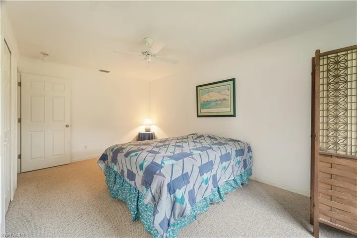 Carpeted bedroom with ceiling fan