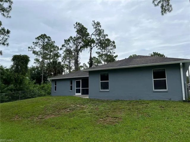 Back of property featuring a yard