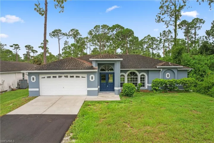 Single story home featuring a front lawn and a garage