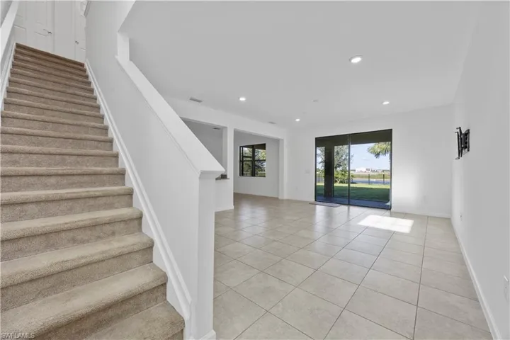 Staircase featuring tile patterned flooring and recessed lighting