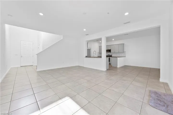 Unfurnished living room with recessed lighting and light tile patterned flooring