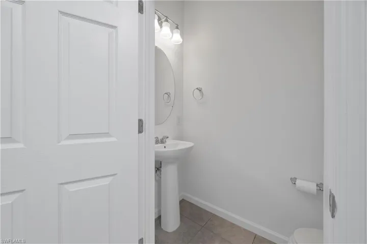 Bathroom featuring light tile patterned floors and baseboards