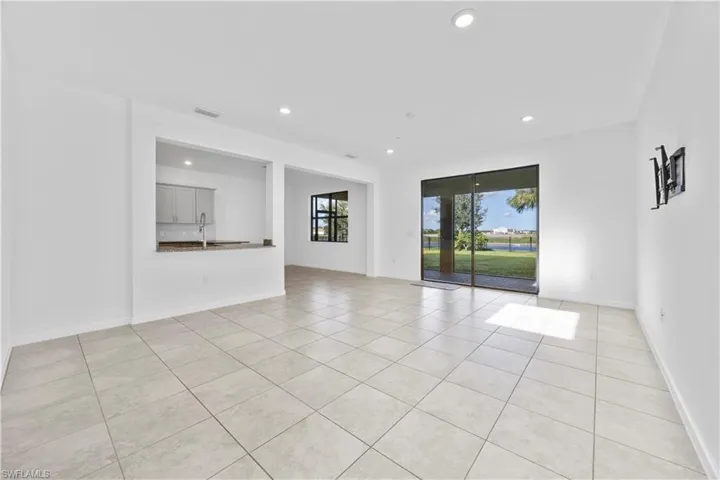 Unfurnished room featuring light tile patterned floors and recessed lighting