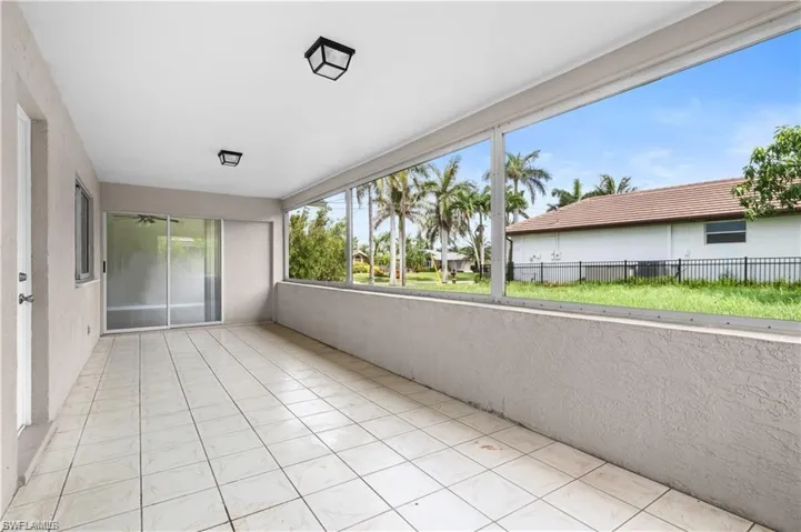 Unfurnished sunroom featuring tile patterned flooring