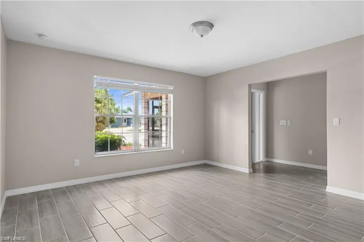 Empty room featuring baseboards and wood finish floors