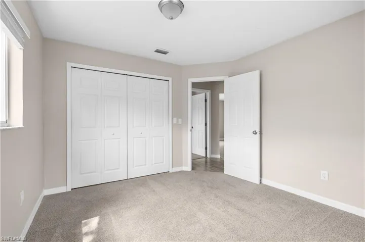 Unfurnished bedroom with carpet and a closet