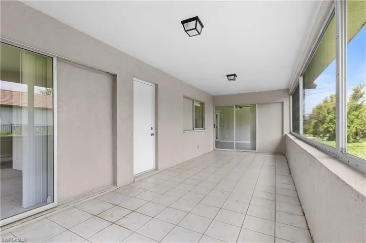 Unfurnished sunroom featuring tile patterned flooring