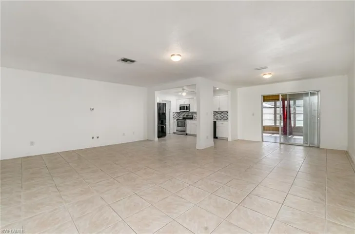 Unfurnished living room featuring a ceiling fan and light tile patterned floors