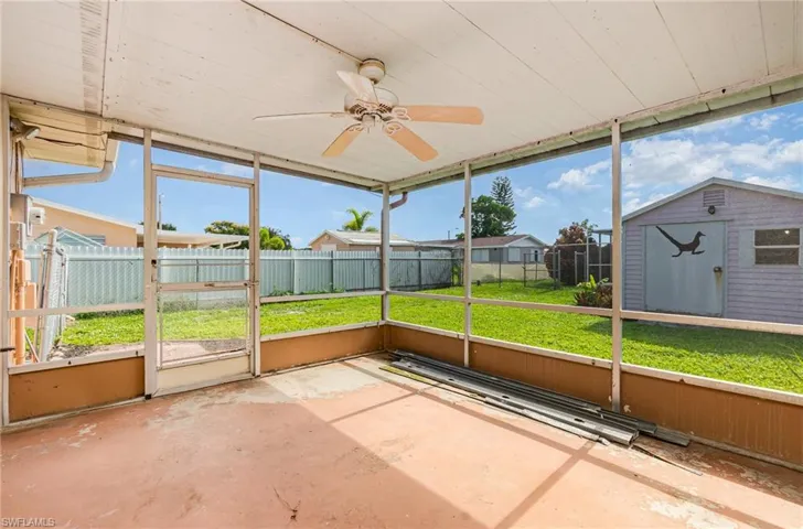 Unfurnished sunroom featuring ceiling fan and healthy amount of natural light