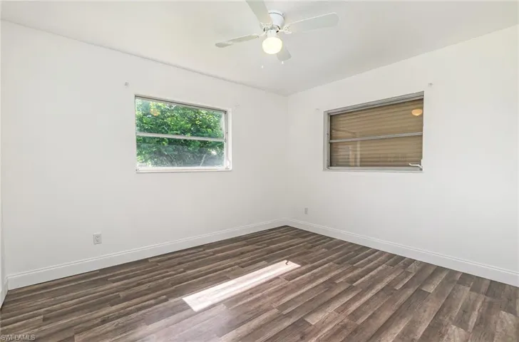 Unfurnished room featuring wood finished floors and a ceiling fan