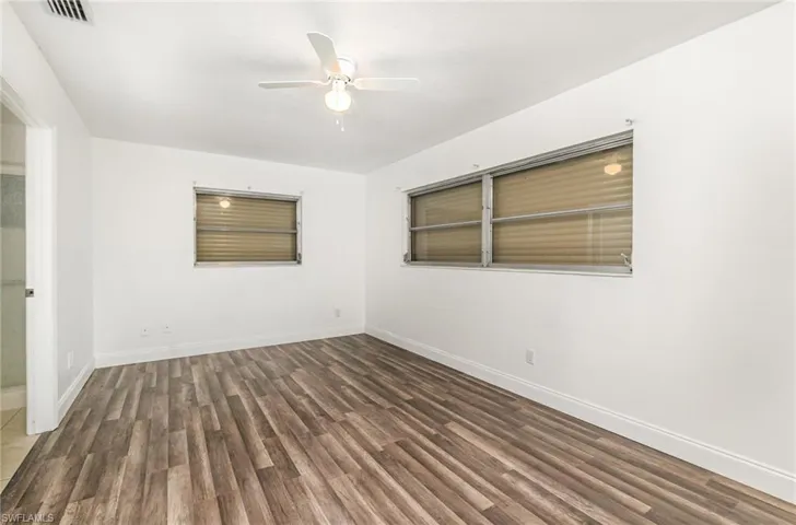 Spare room featuring wood finished floors and ceiling fan