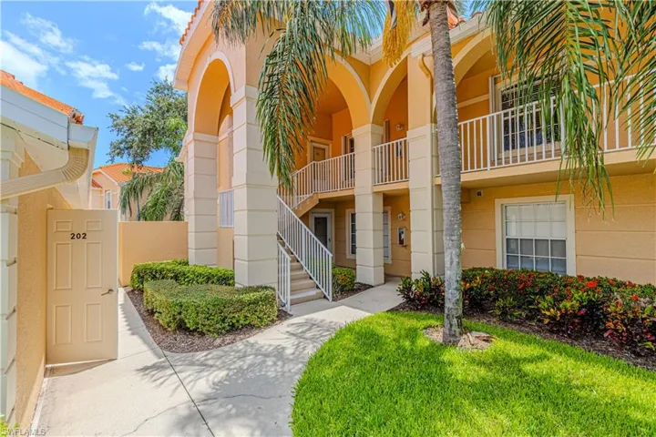 Multi-story building featuring stucco exterior and arched architectural details