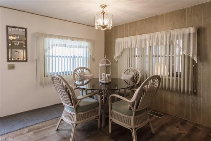 Dining space with a drop light and and luxury vinyl plank flooring