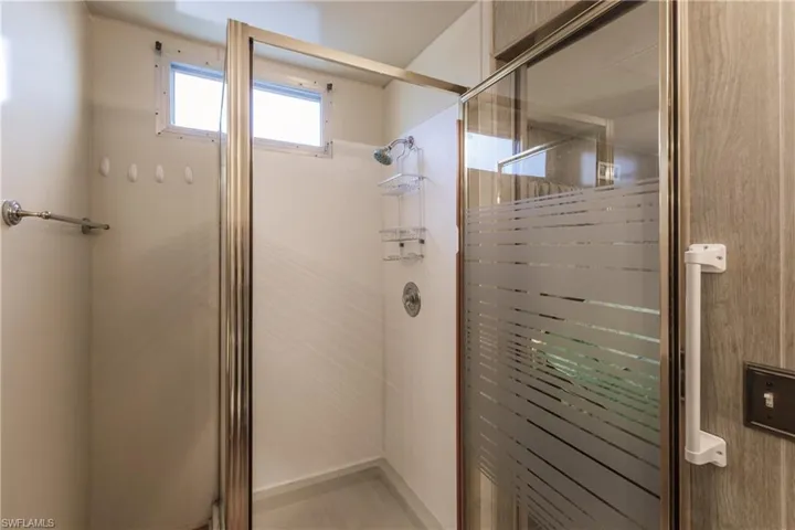 Bathroom featuring an all glass, walk-in shower