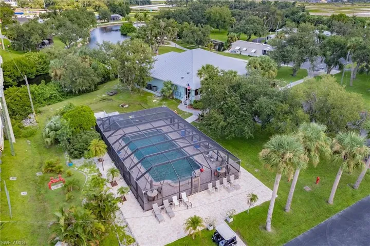 View of community pool, waterside clubhouse and dockhouse