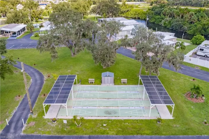 Drone / aerial view of shuffleboard featuring a water view