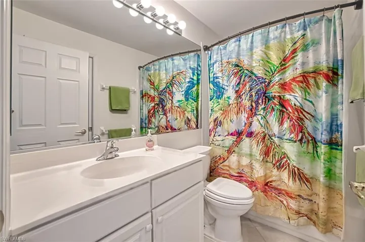Bathroom with tile patterned flooring, vanity, and toilet