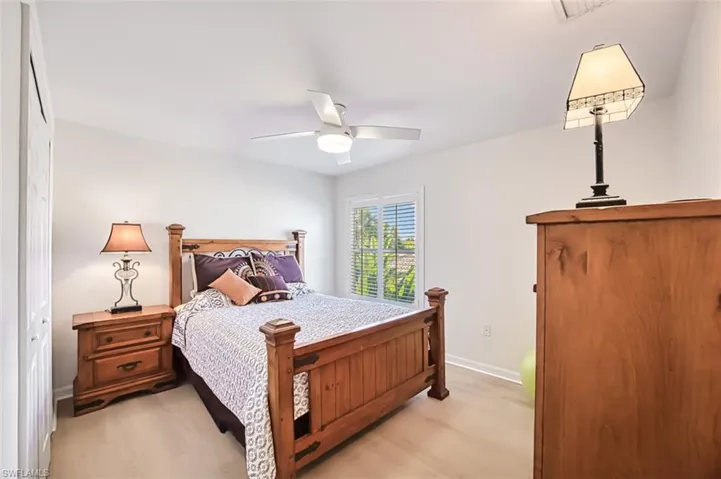 Bedroom with ceiling fan, a closet, and light hardwood / wood-style floors