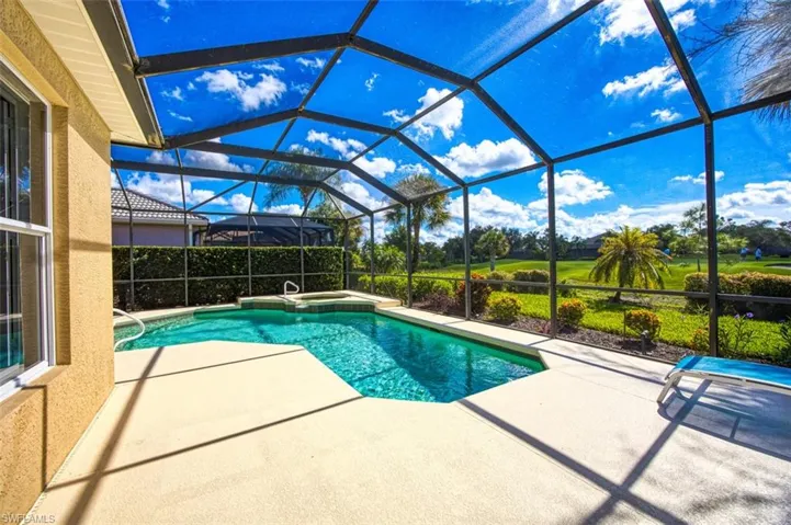 View of pool with a lanai, an in ground hot tub, and a patio