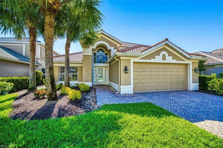 View of front of house with a front yard and a garage