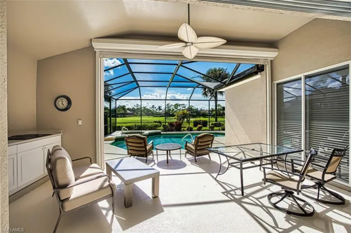 View of patio with a lanai and ceiling fan