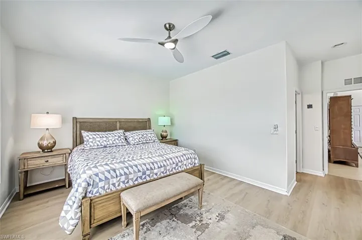 Bedroom with ceiling fan and light hardwood / wood-style flooring