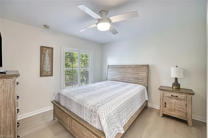 Bedroom with light wood-type flooring and ceiling fan