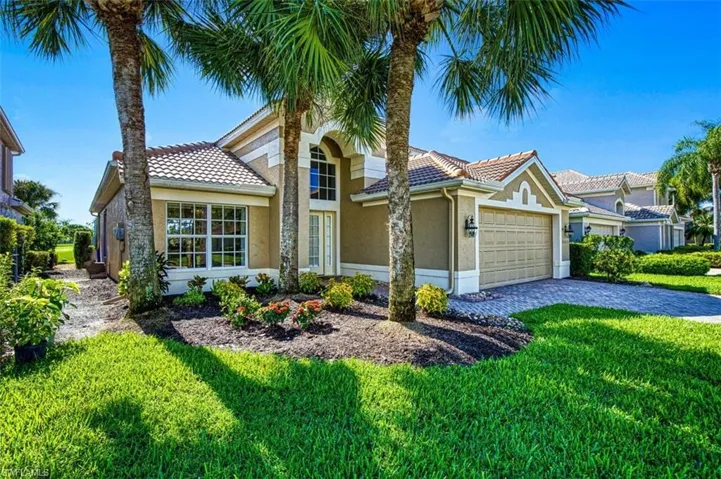 Mediterranean / spanish house with a front yard and a garage