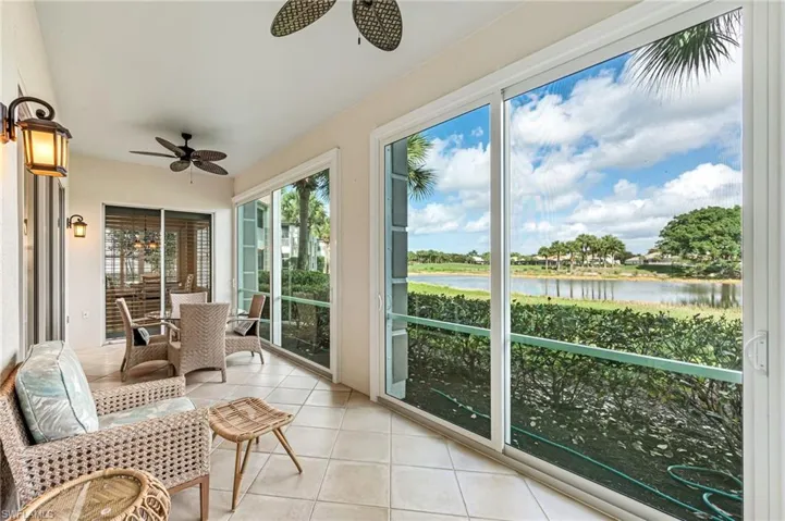 Sunroom / solarium featuring a water view and tile patterned floors. The impact windows make this room part of the interior and available to use year round.