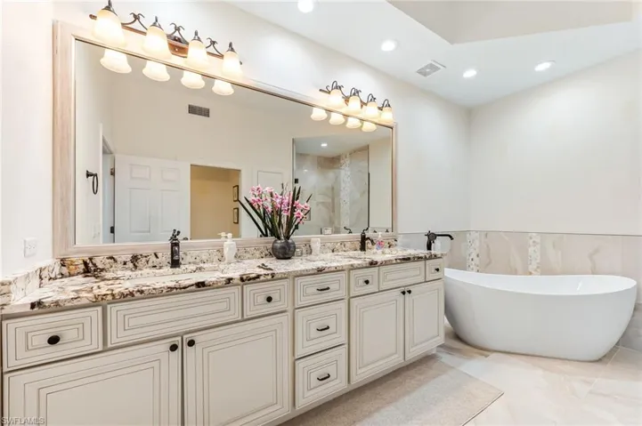 Full bathroom with a freestanding bath, double vanity, and a separate shower.