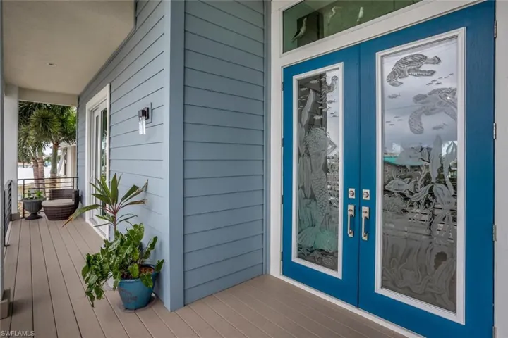 Second story doorway  featuring etched glass and covered balcony