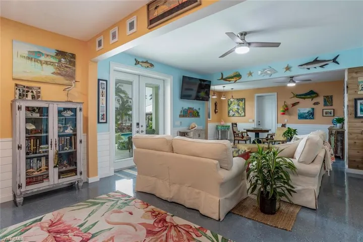 Ground floor bonus room with ceiling fan, epoxy floor and French doors to back yard