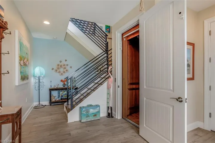 Entry Foyer, elevator, custom metal railings on staircase