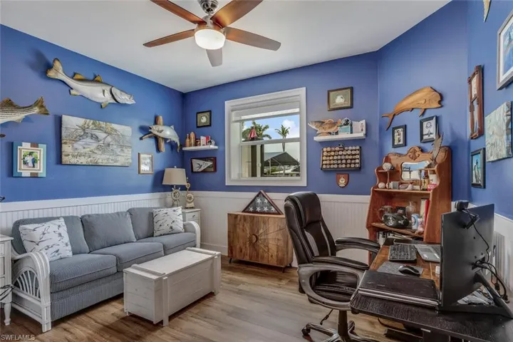 Office area with wood-type flooring and ceiling fan