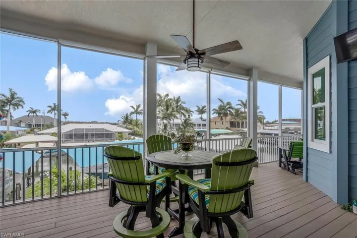 Screened upstairs balcony porch with a healthy amount of sunlight, roller shades and ceiling fan