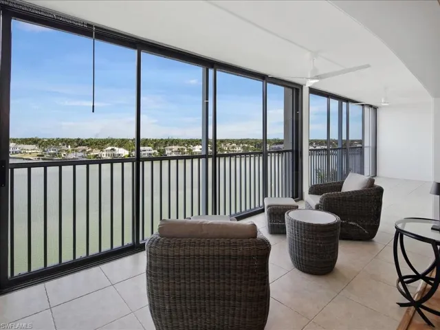 Sunroom / solarium featuring a water view