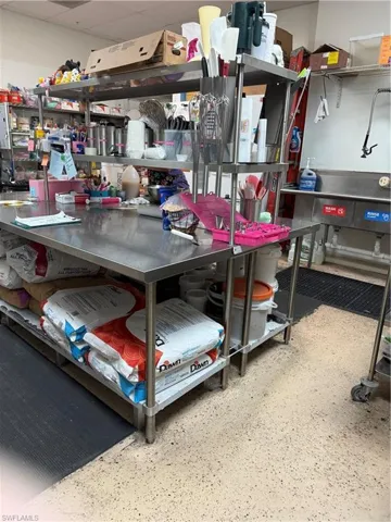 Commercial-grade stainless steel workstation featuring an integrated shelving system