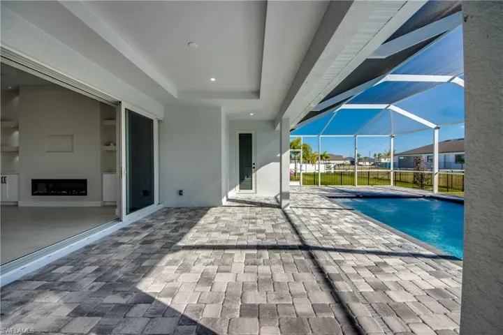 Swimming pool with a patio, a sunroom, and a lanai