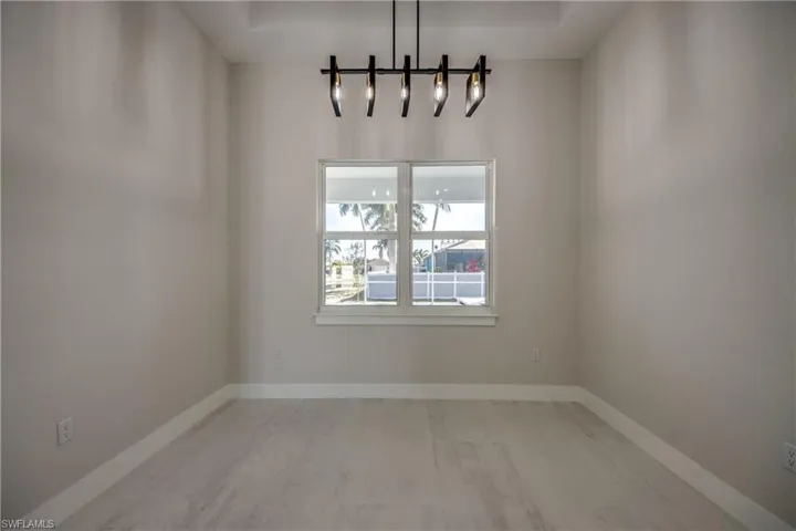 Unfurnished dining area with baseboards