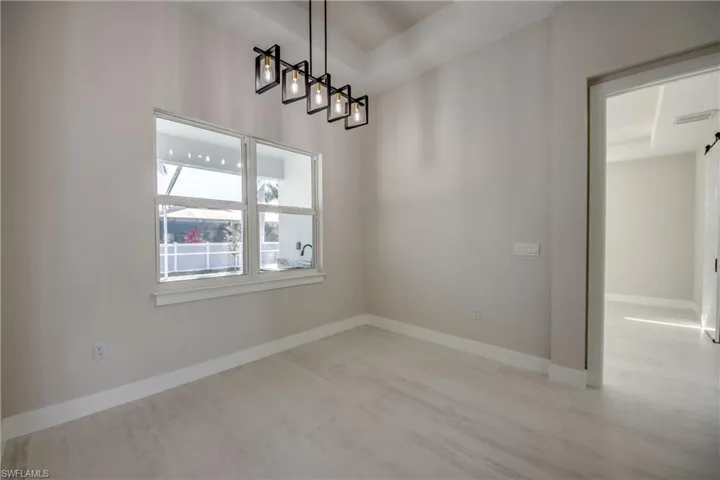 Unfurnished dining area with baseboards